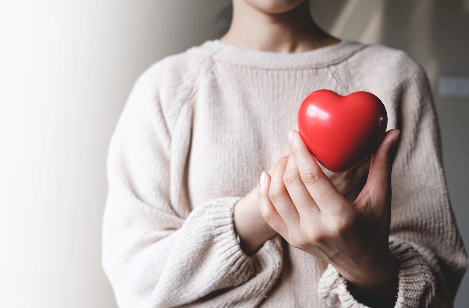 woman holding a red heart